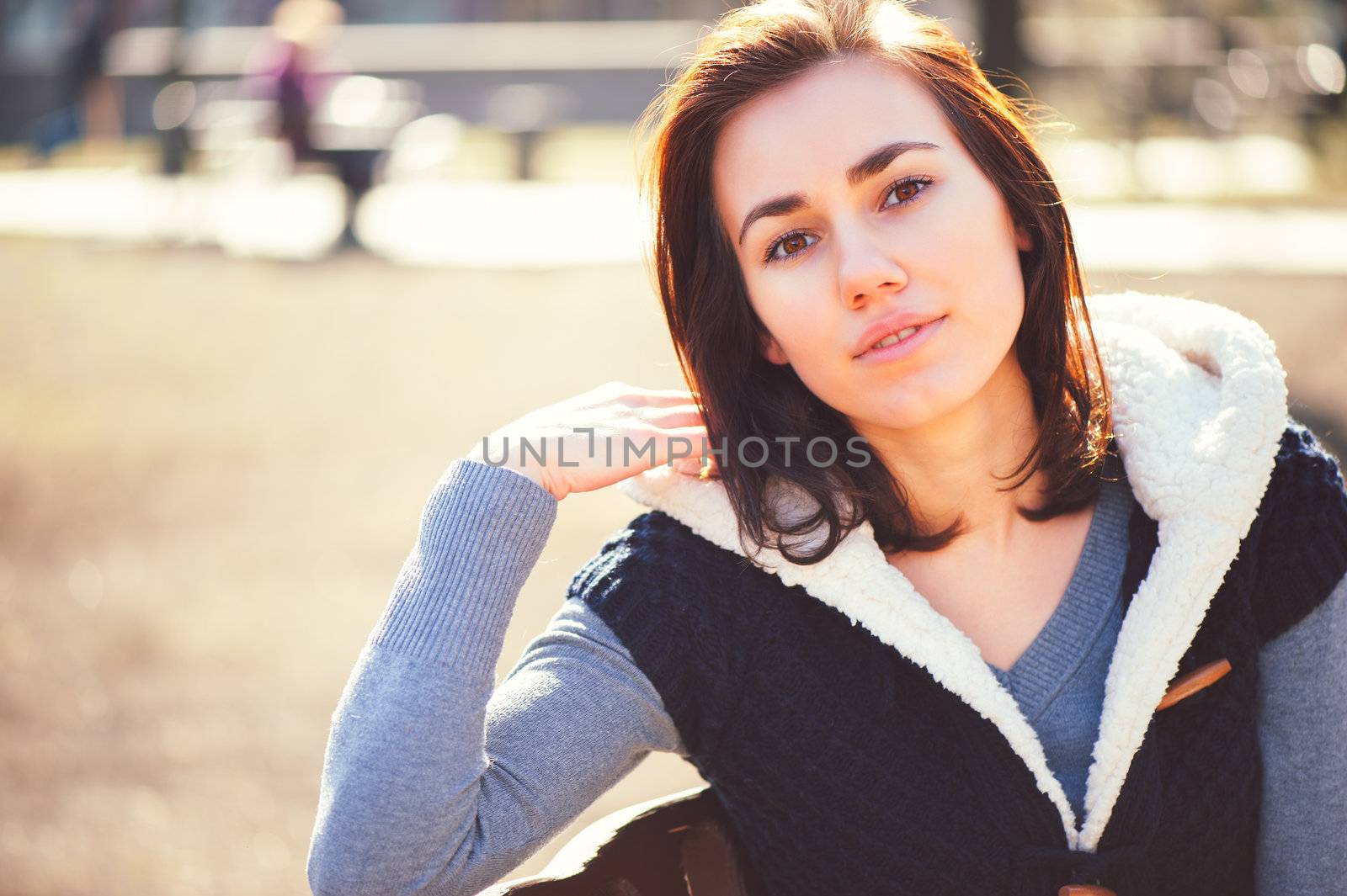 Portrait of young girl sitting on a bench by nvelichko