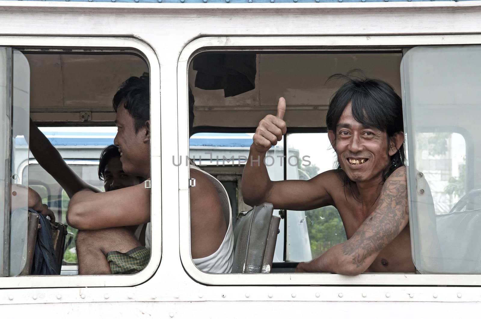 man smiling on yangon myanmar bus by jackmalipan