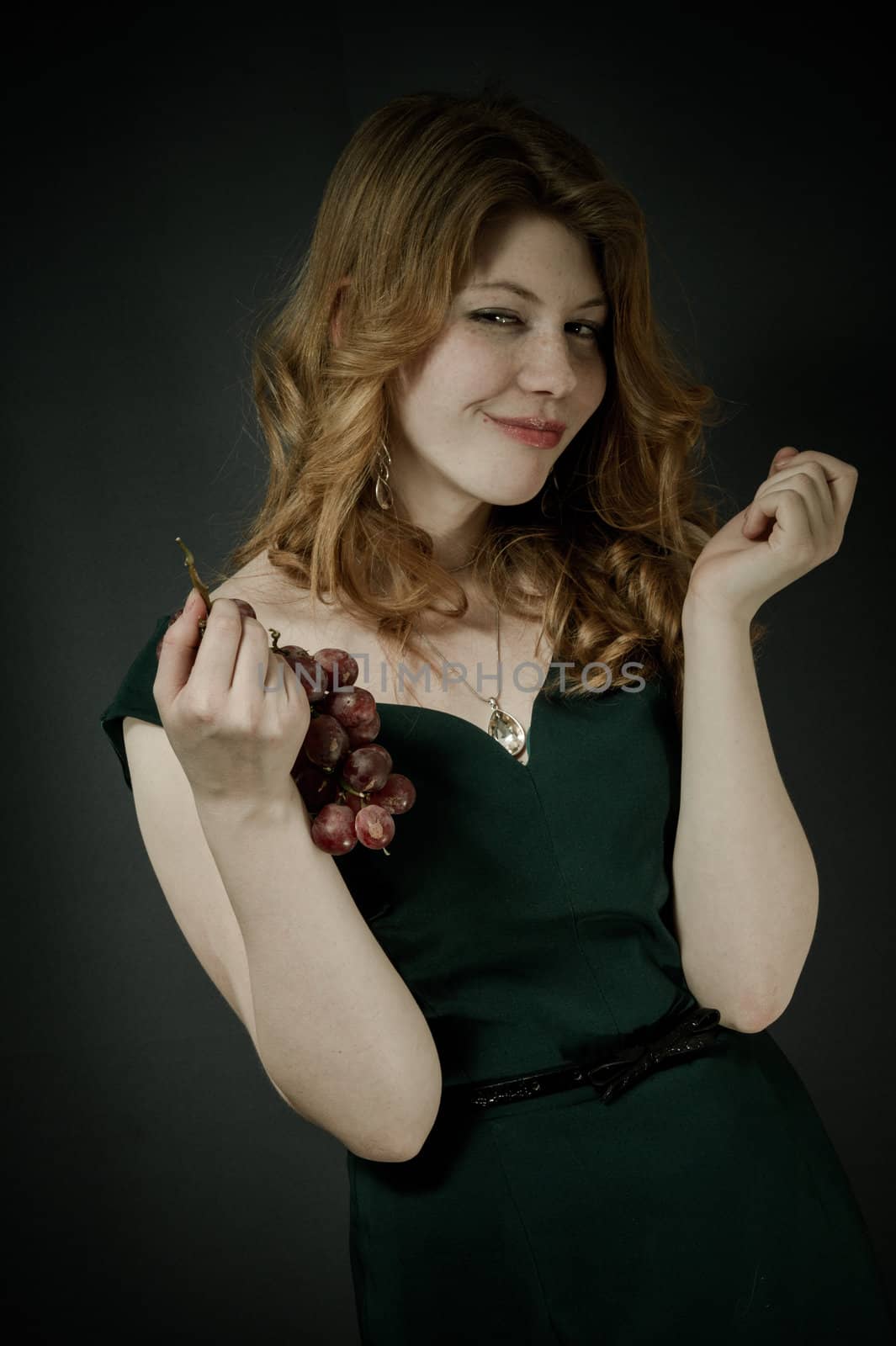 Beutiful young woman  with red hairs in green dress.