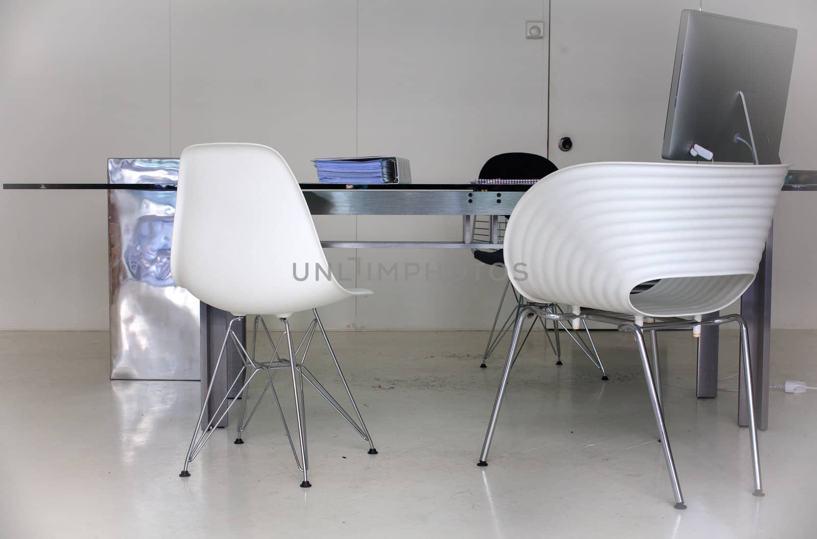 View of desk and chairs in a white office