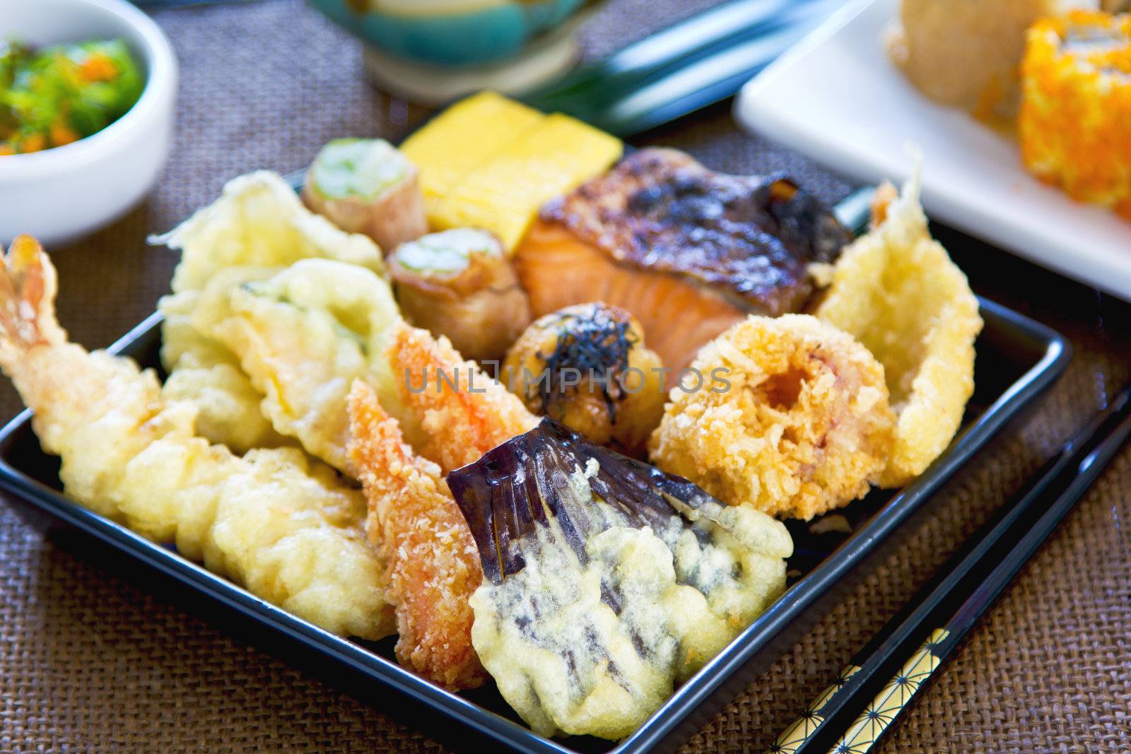 Japanese Bento set contain varieties of vegetables and fish in batter with Nori maki