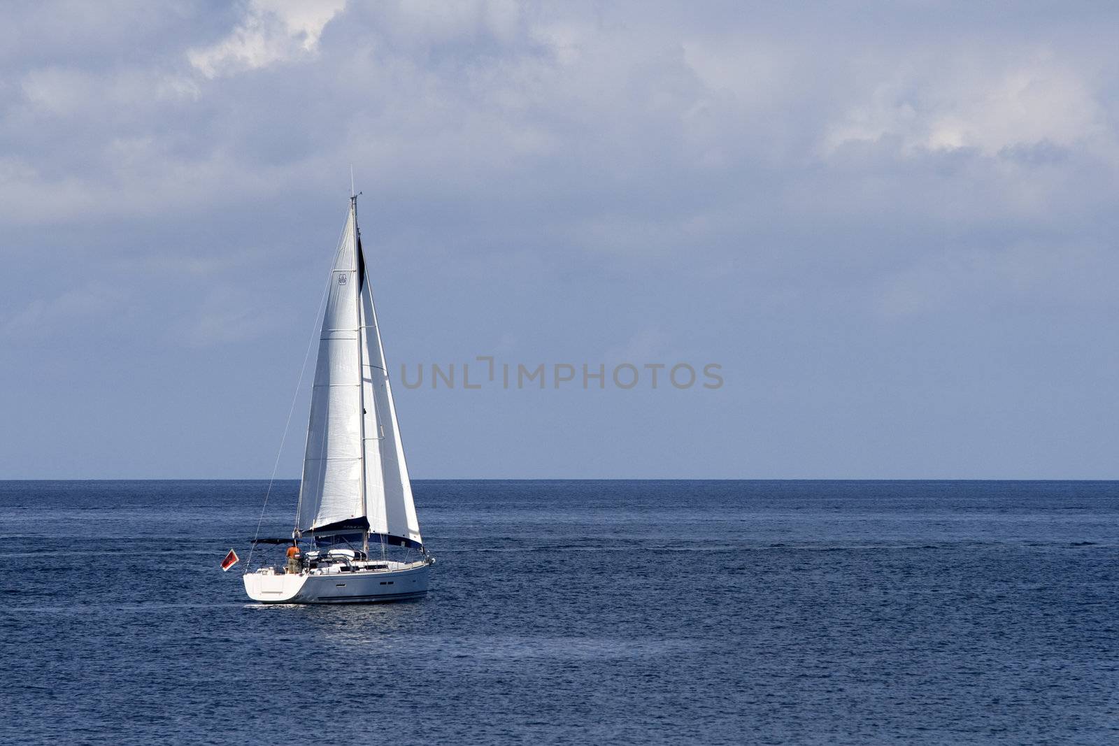 A sailing boat sailing against the horizon