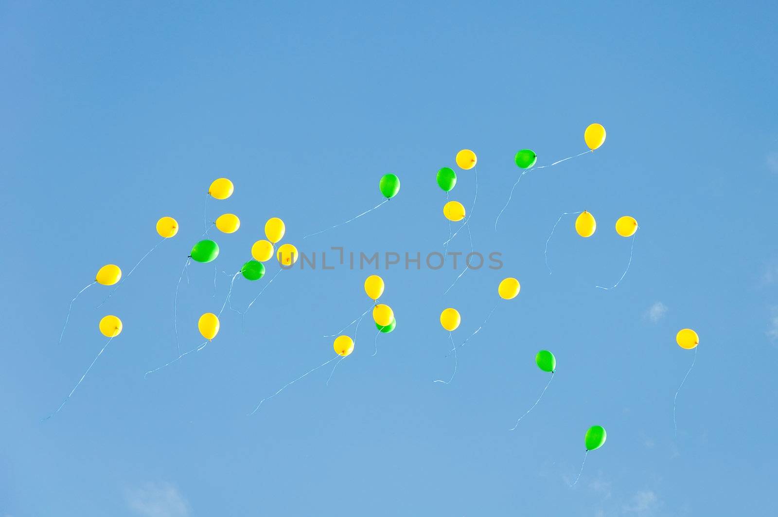 flight yellow and green small balloons