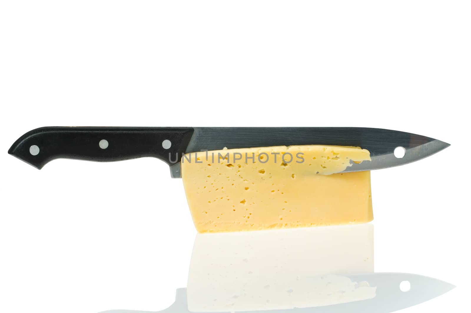 cheese piece with knife is reflected in a white background