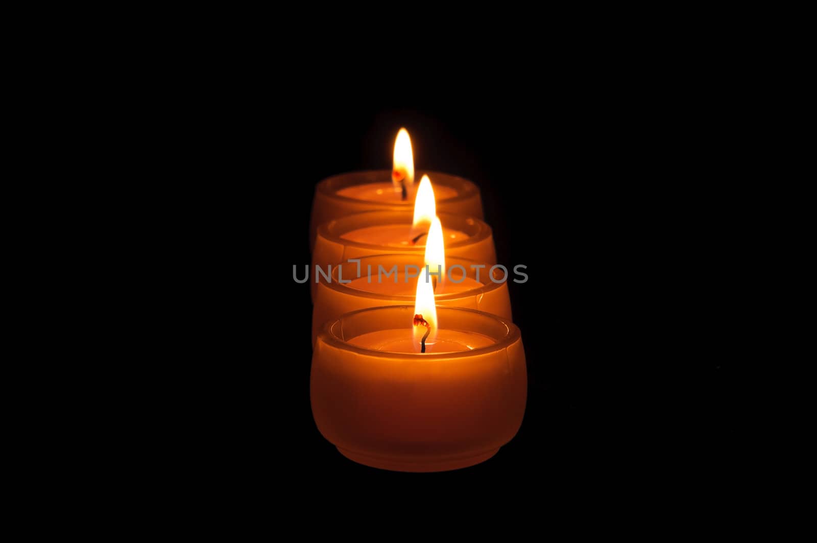 Beautiful candles burning on a black background