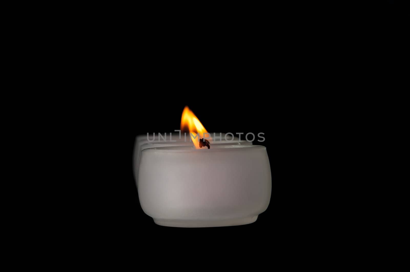 Beautiful candles burning on a black background