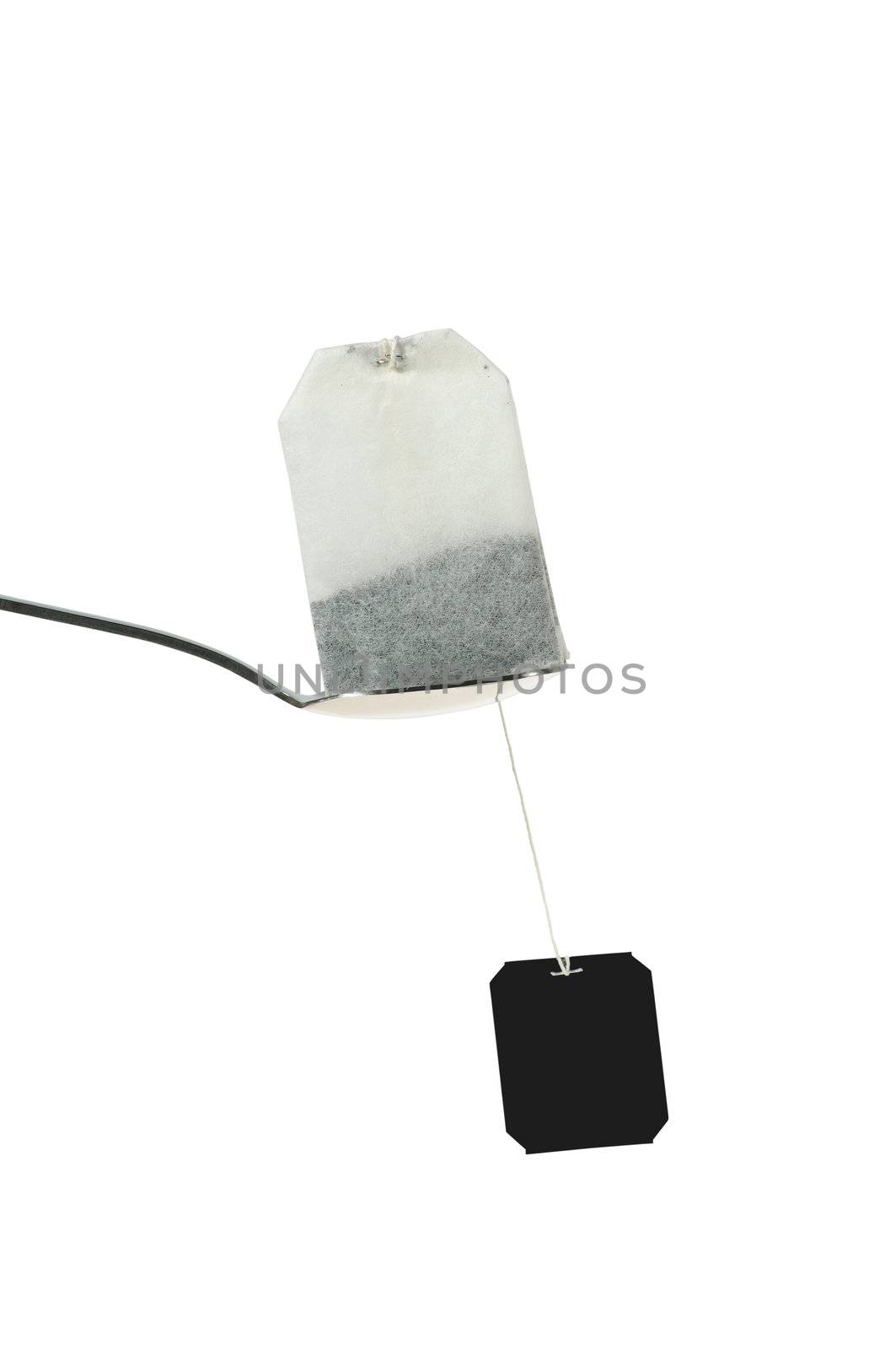 teabag with spoon isolated on white