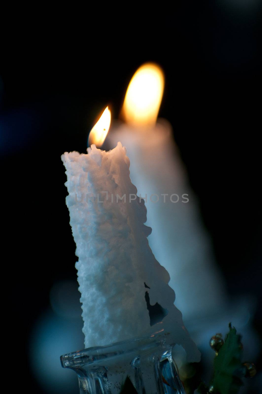 Burning candle against other blur candle