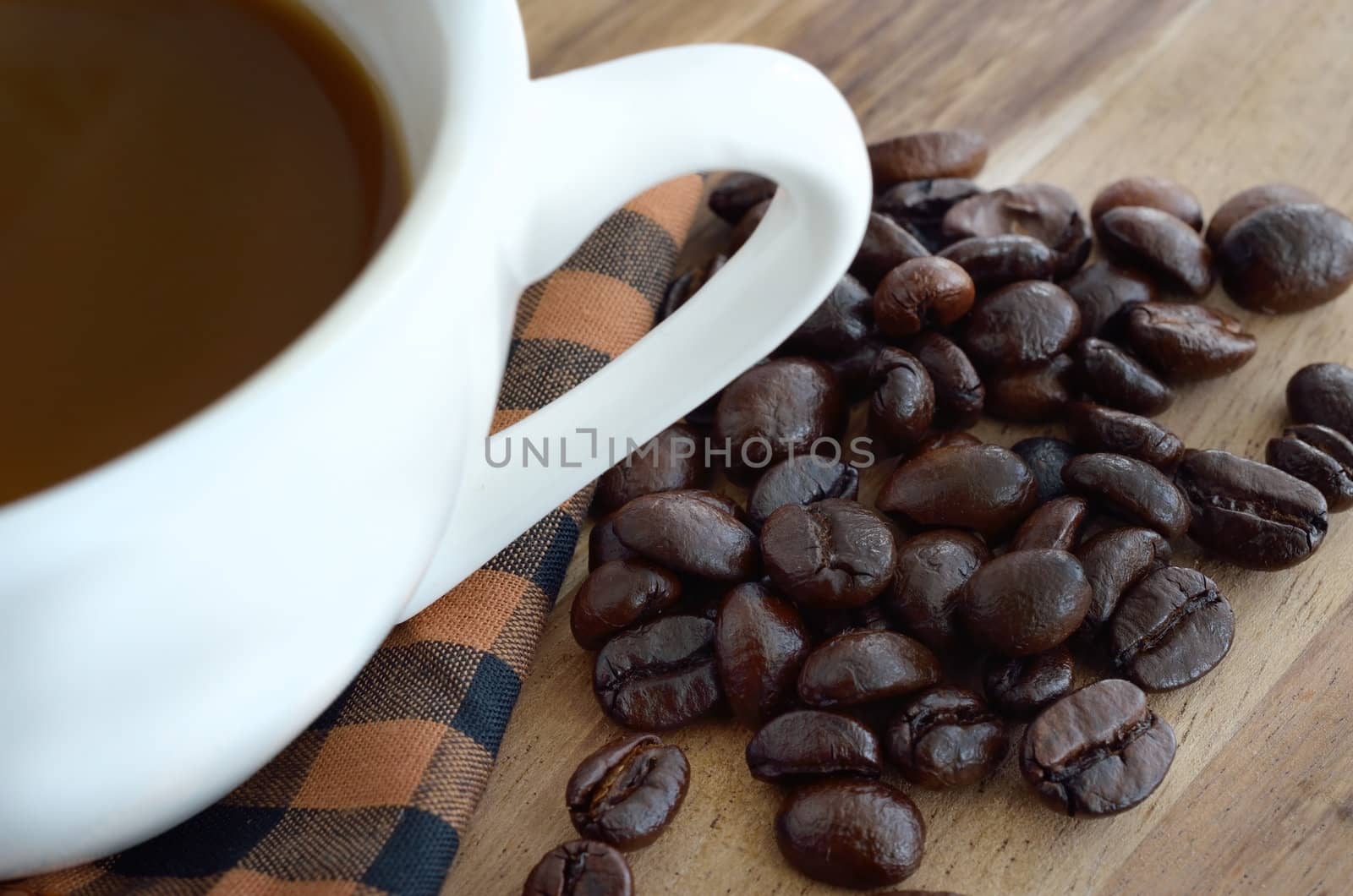 Coffee cup and beans  on wooden