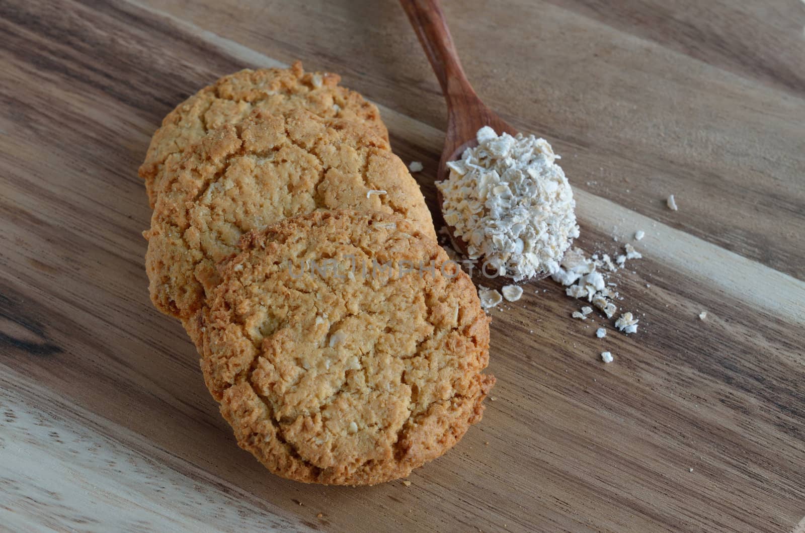 Oatmeal cookies on wood background.