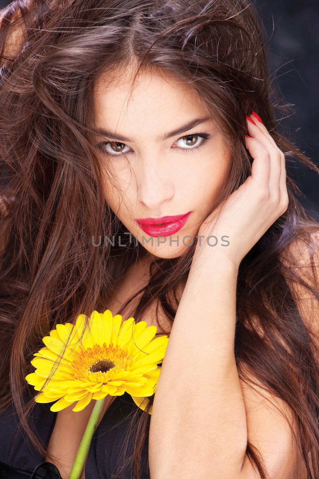 Pretty black dressed woman with long hair and yellow daisy