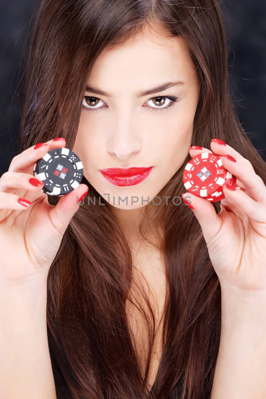 Pretty woman holding chips for gambling