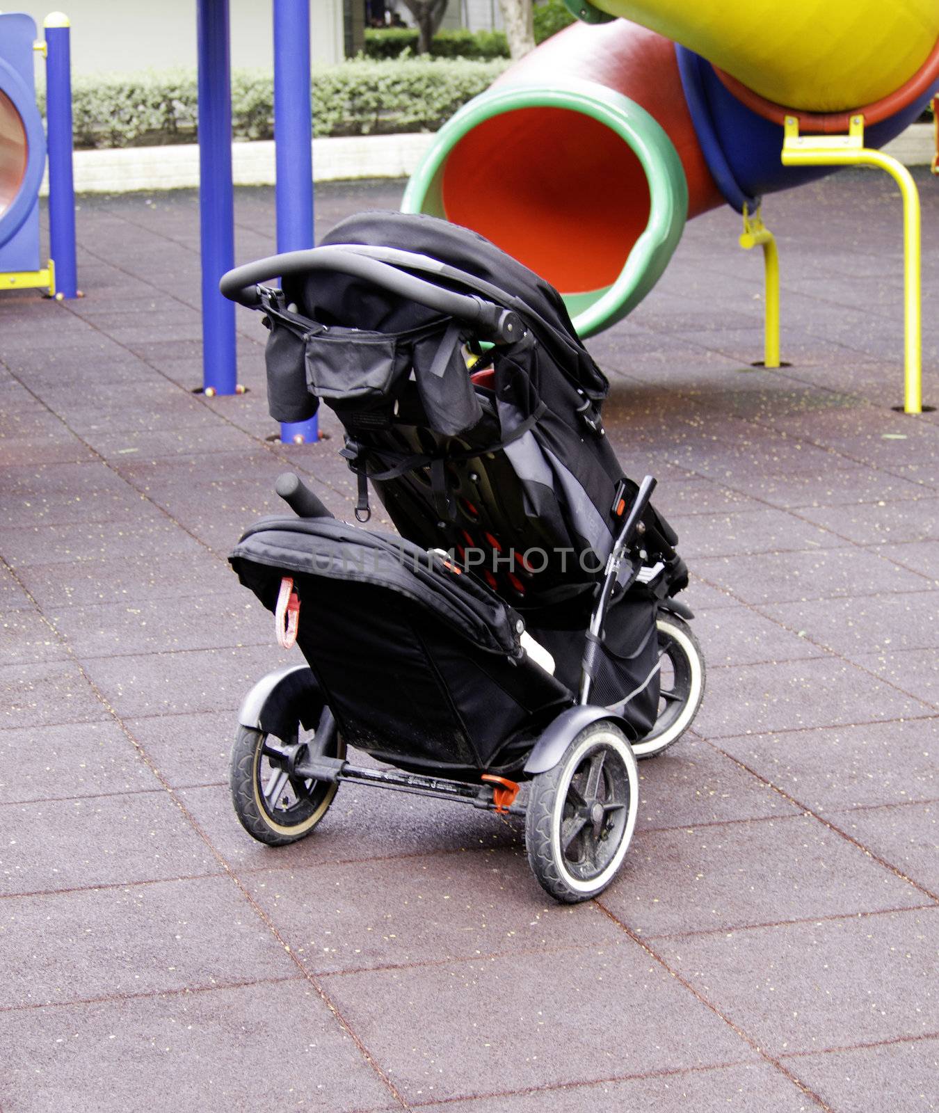 Single baby carriage in playground