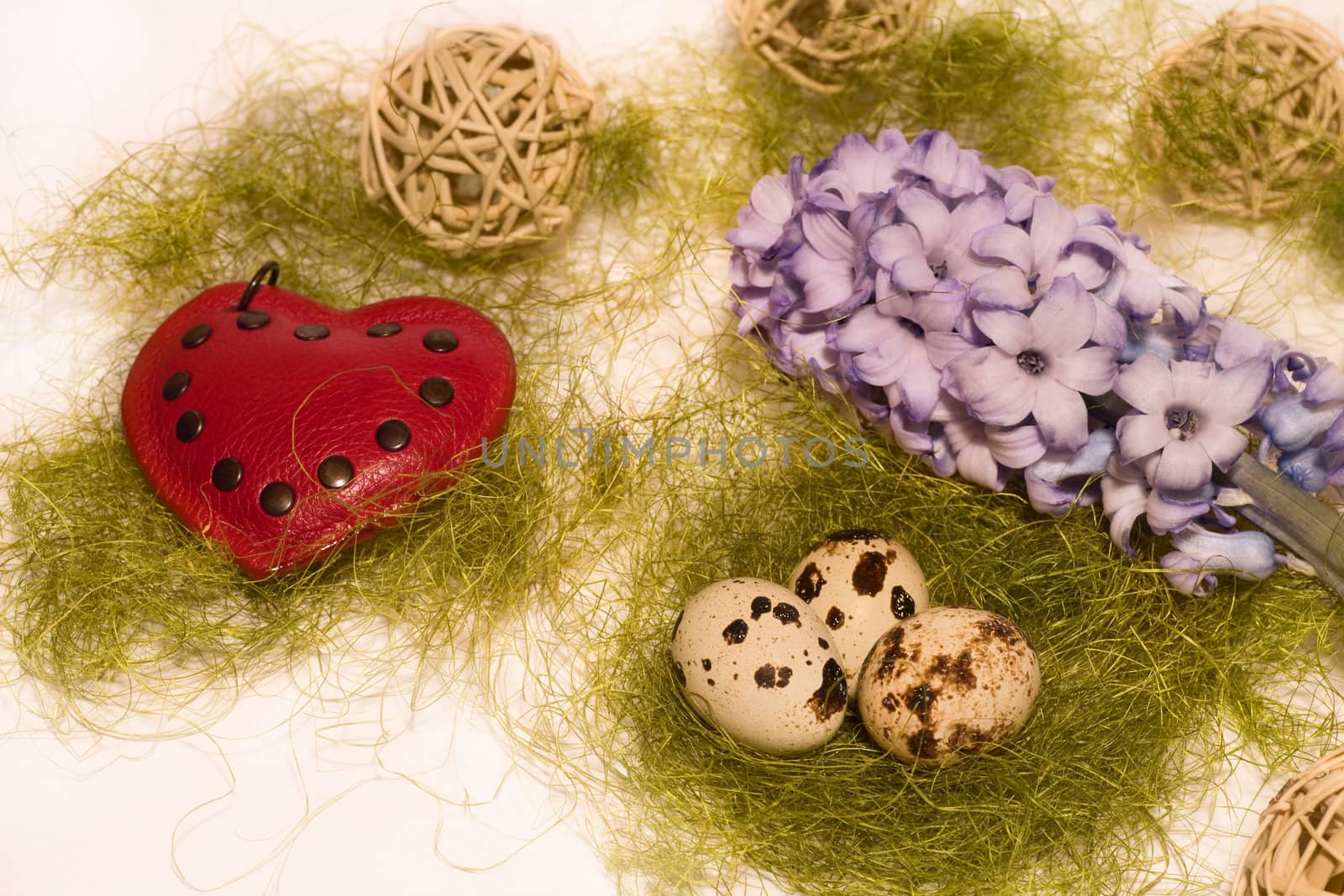 Easter eggs  in nest, blue hyacinth, read heart and wooden balls
