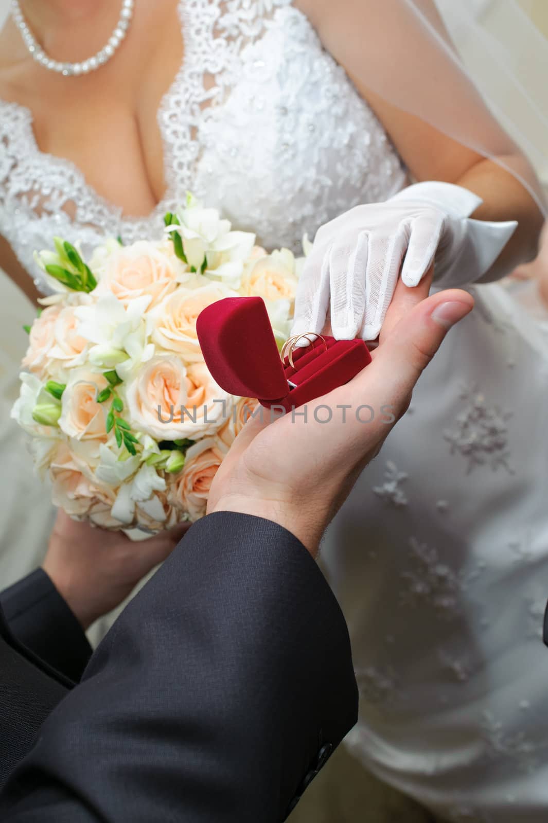 groom gives to bride a gold ring. Love in practice.