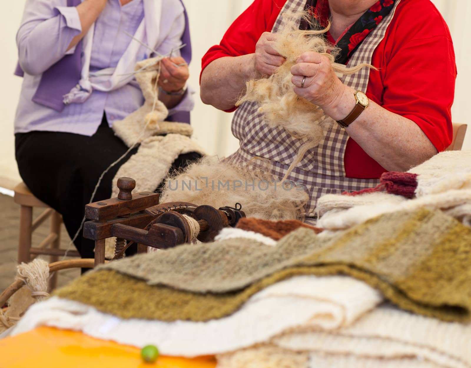 Photo of a elderly woman that spinning wool