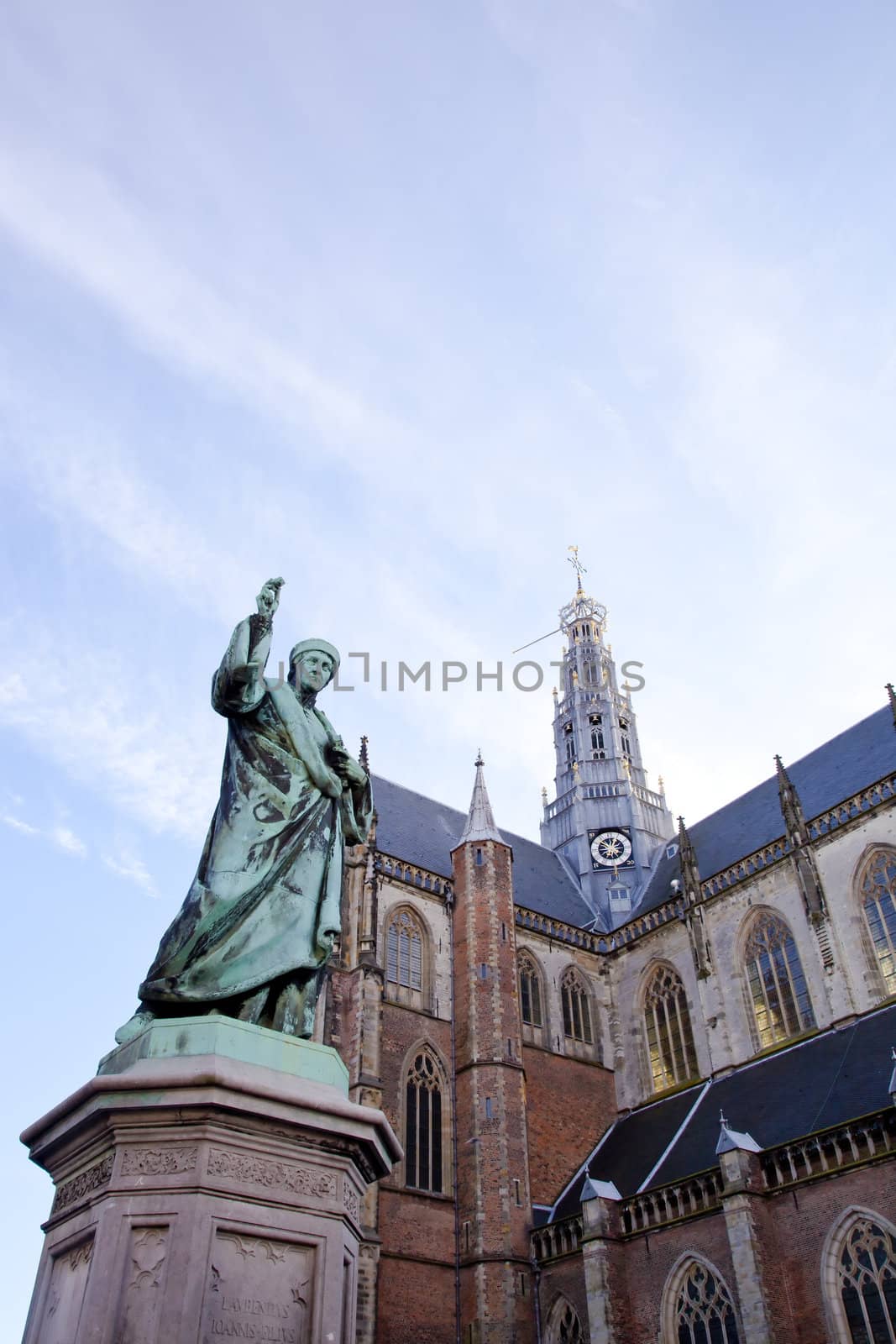 Cathedral St. Bavo with statue of printing inventor Laurens Janszoon Coster at big square Haarlem, The Netherlands