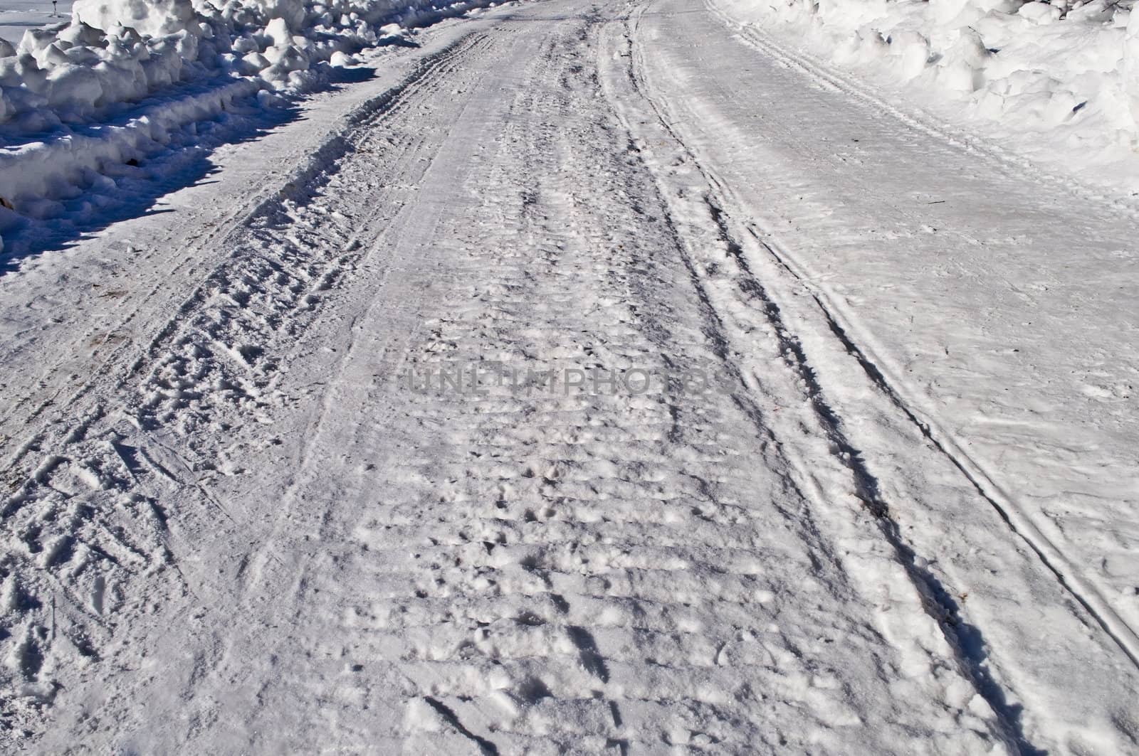 Close up of snowy road background, winter sunny day