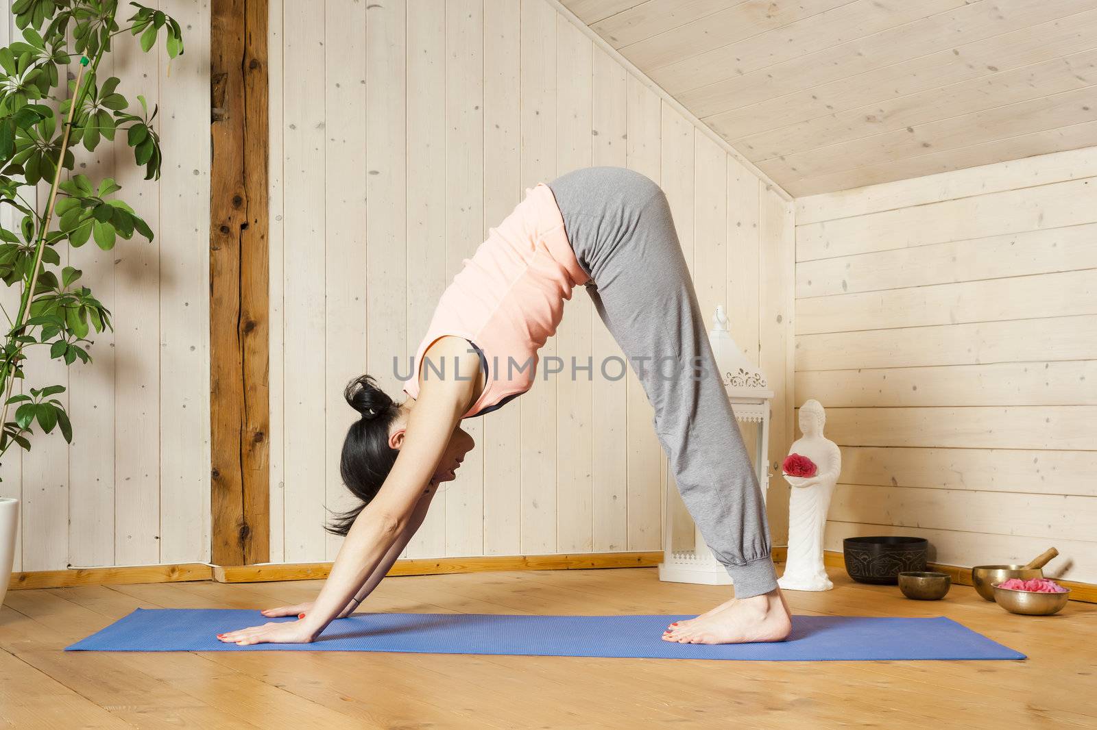 An image of a pretty woman doing yoga at home