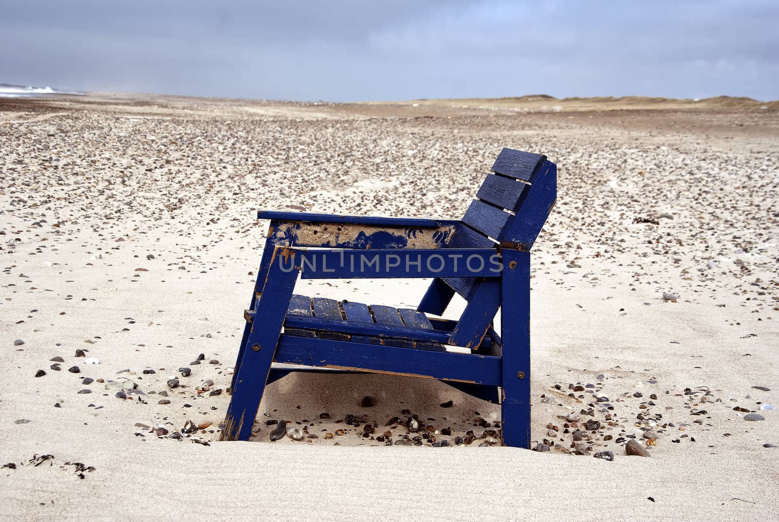 A stranded chair on the beach in denmark