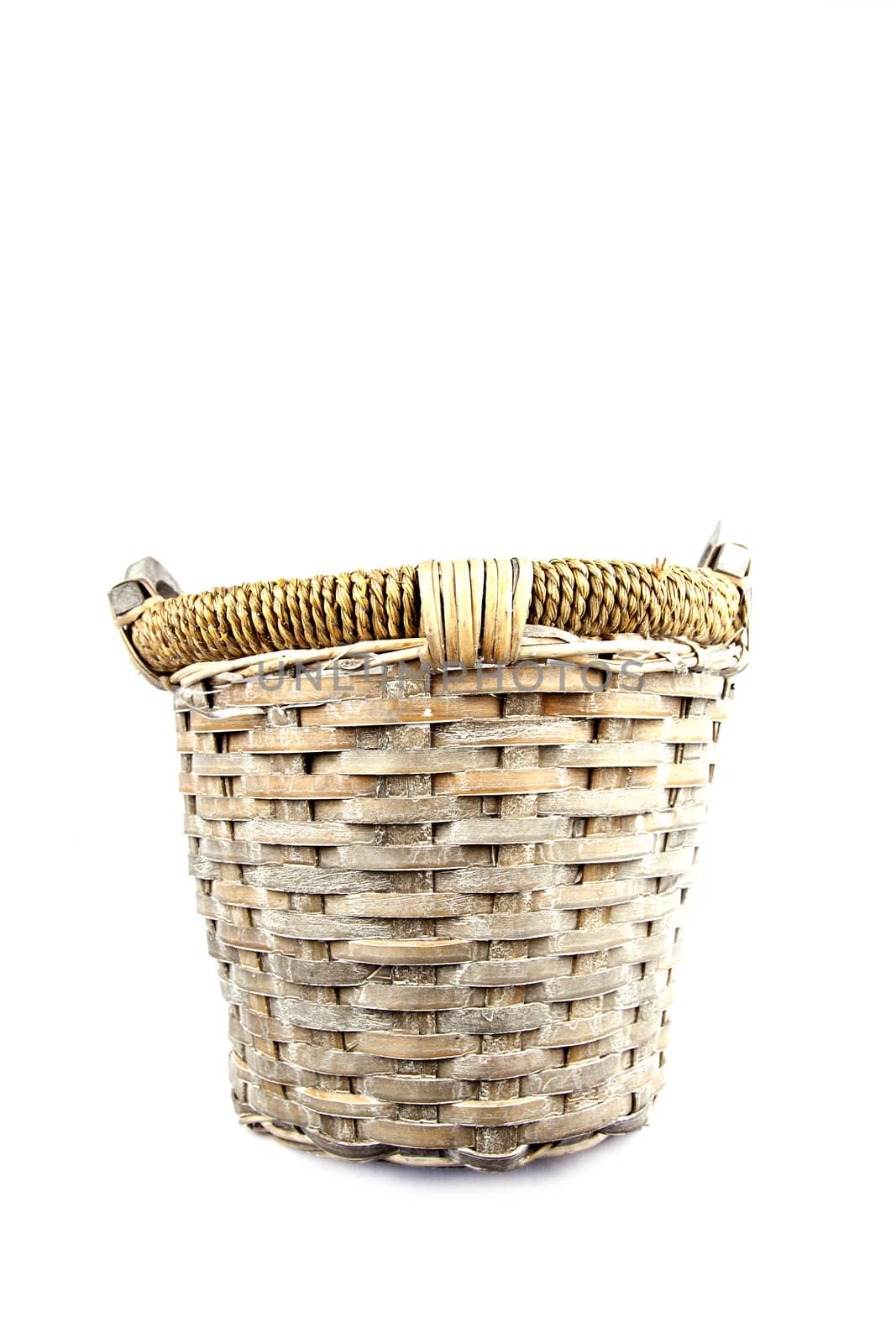 Old basket made of reed isolated on white background