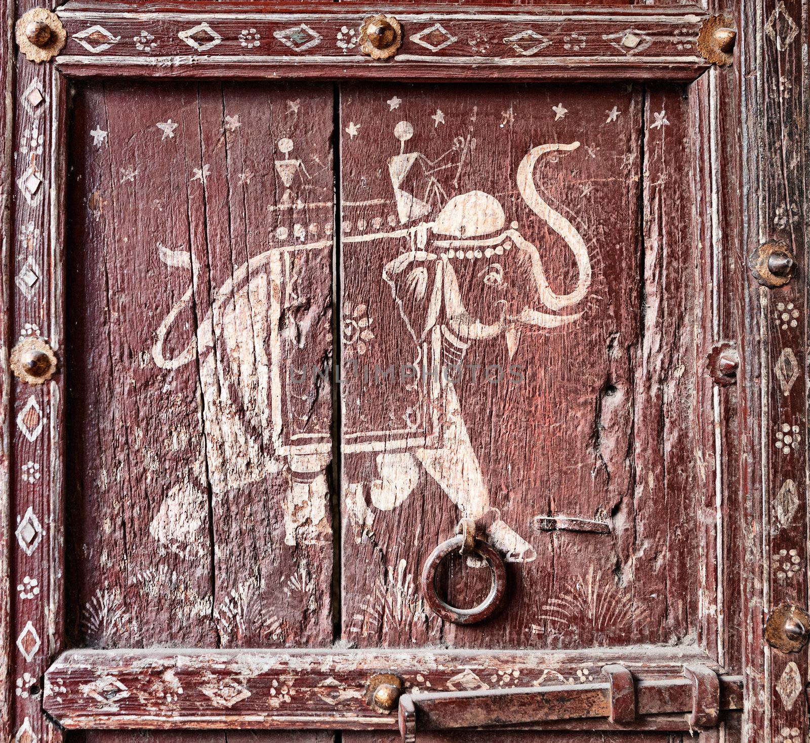 Old wooden door with a picture of an elephant. Fragment. Rajasthan, India