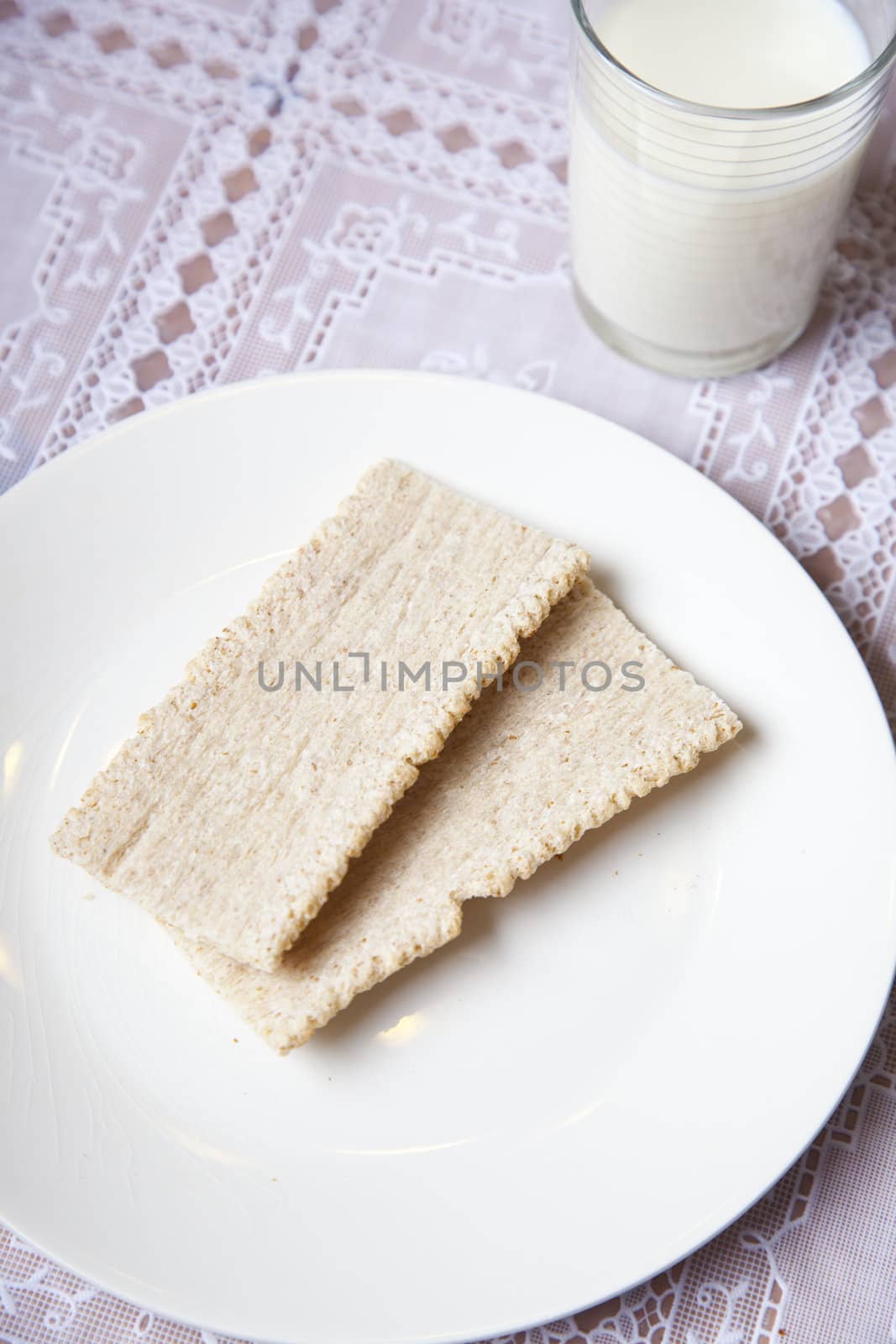 Light breakfast with crackers and milk on table
