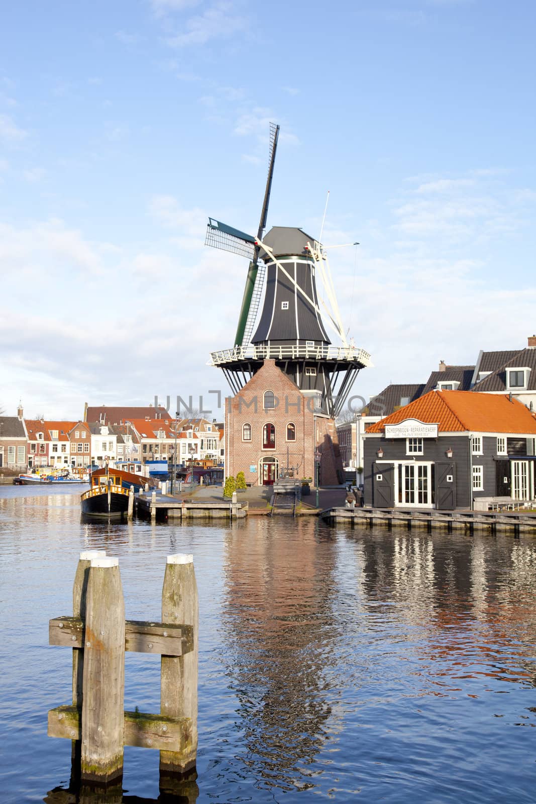 Classic windmill at canal in The Netherlands