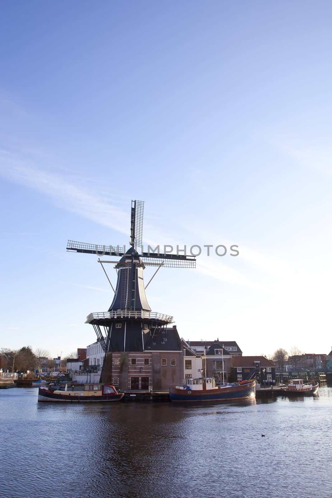 Classic windmill at canal in The Netherlands