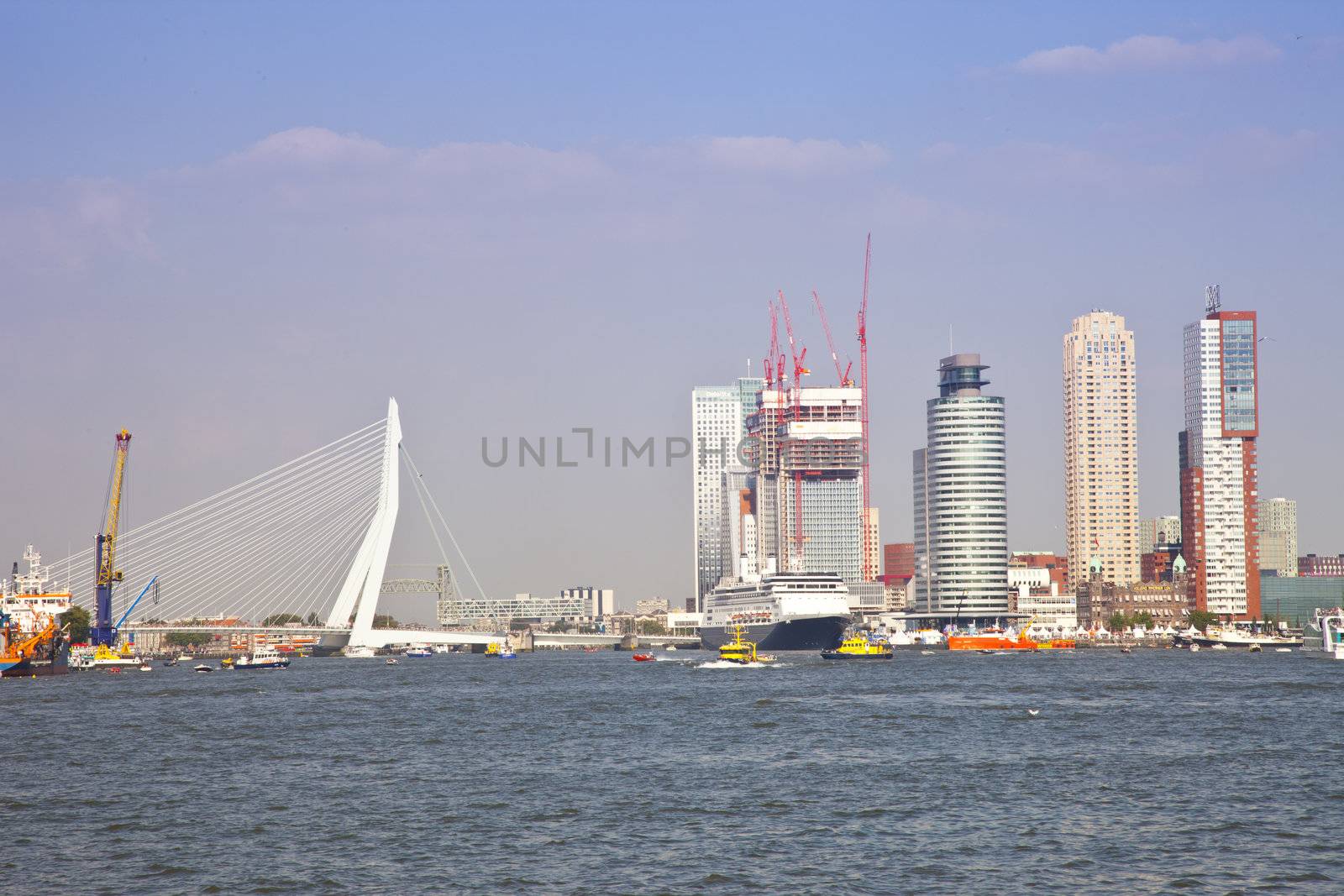 Skyline with water of Dutch city Rotterdam with buildings and bridge