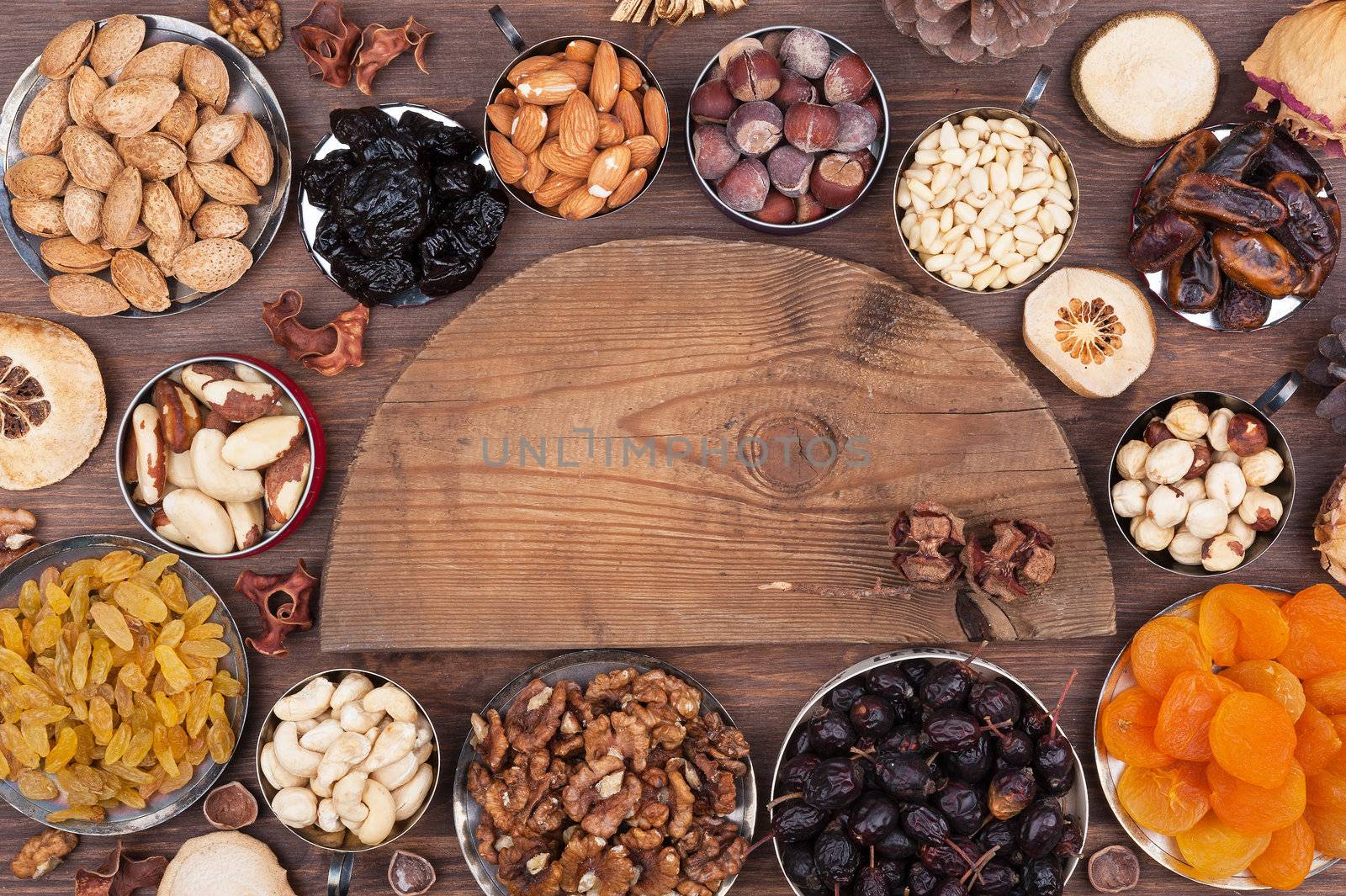 Wooden semi-circle, surrounded by nuts and fruits