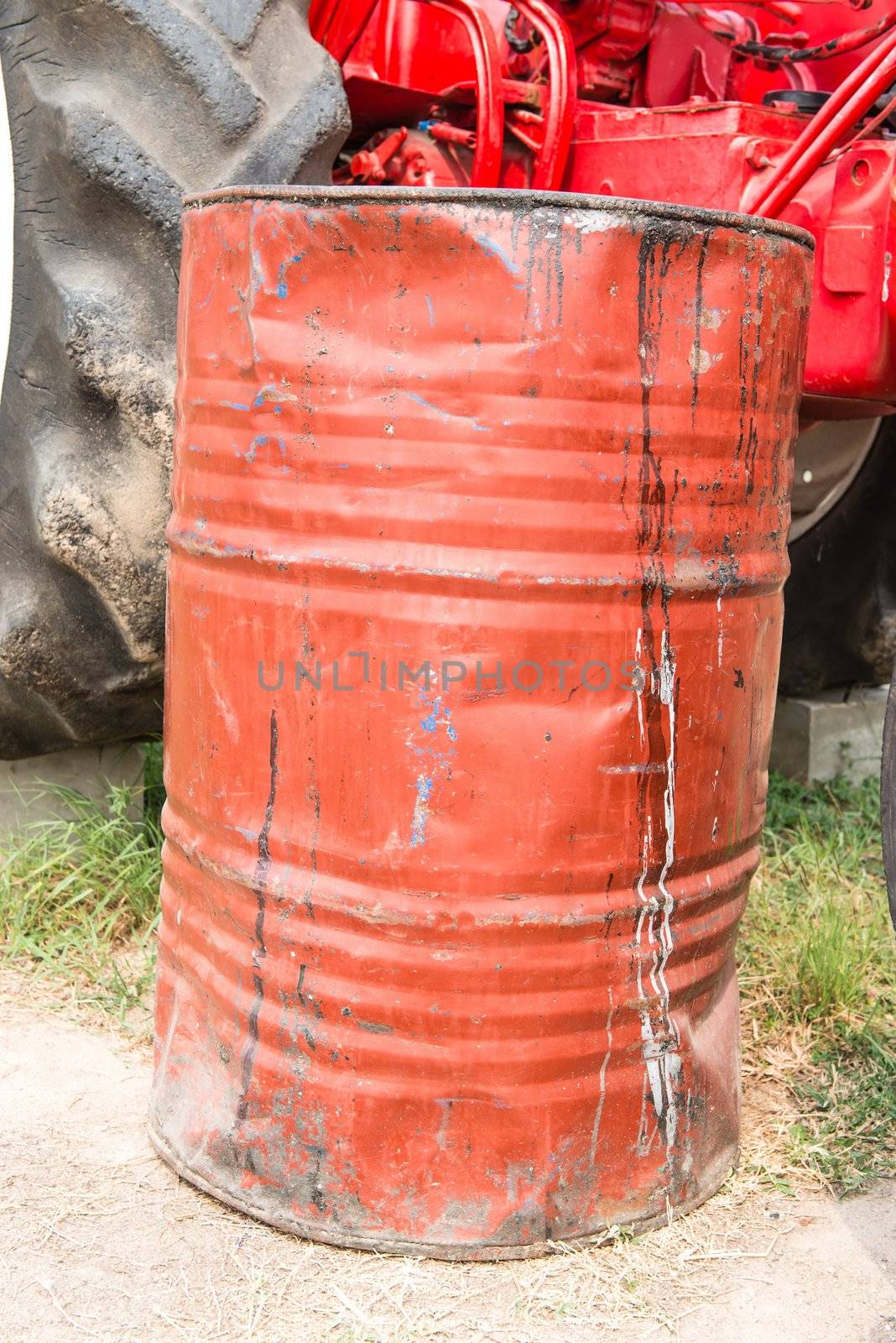 Red dirty rusty and damaged oil drum, taken up front