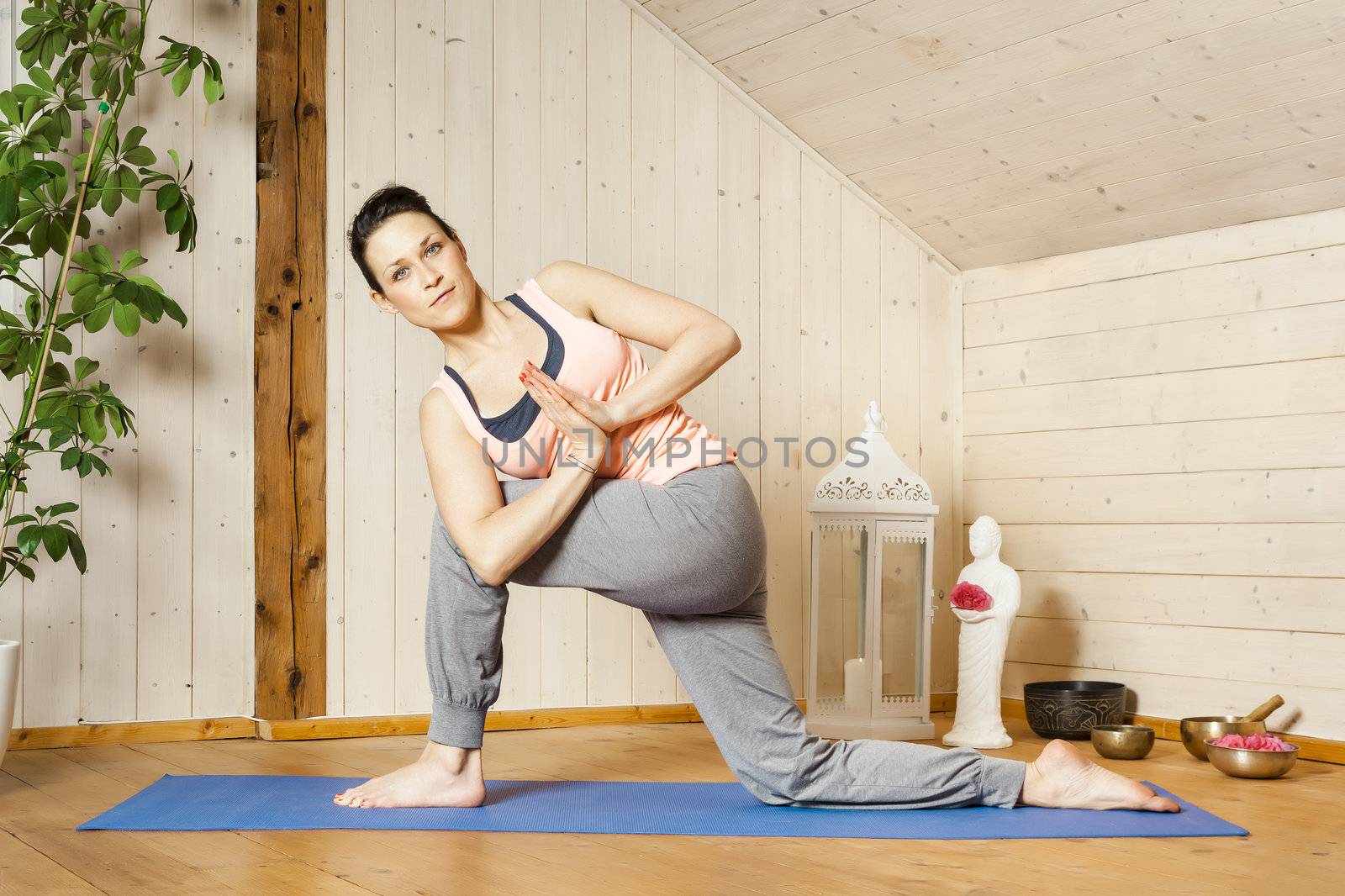 An image of a pretty woman doing yoga at home