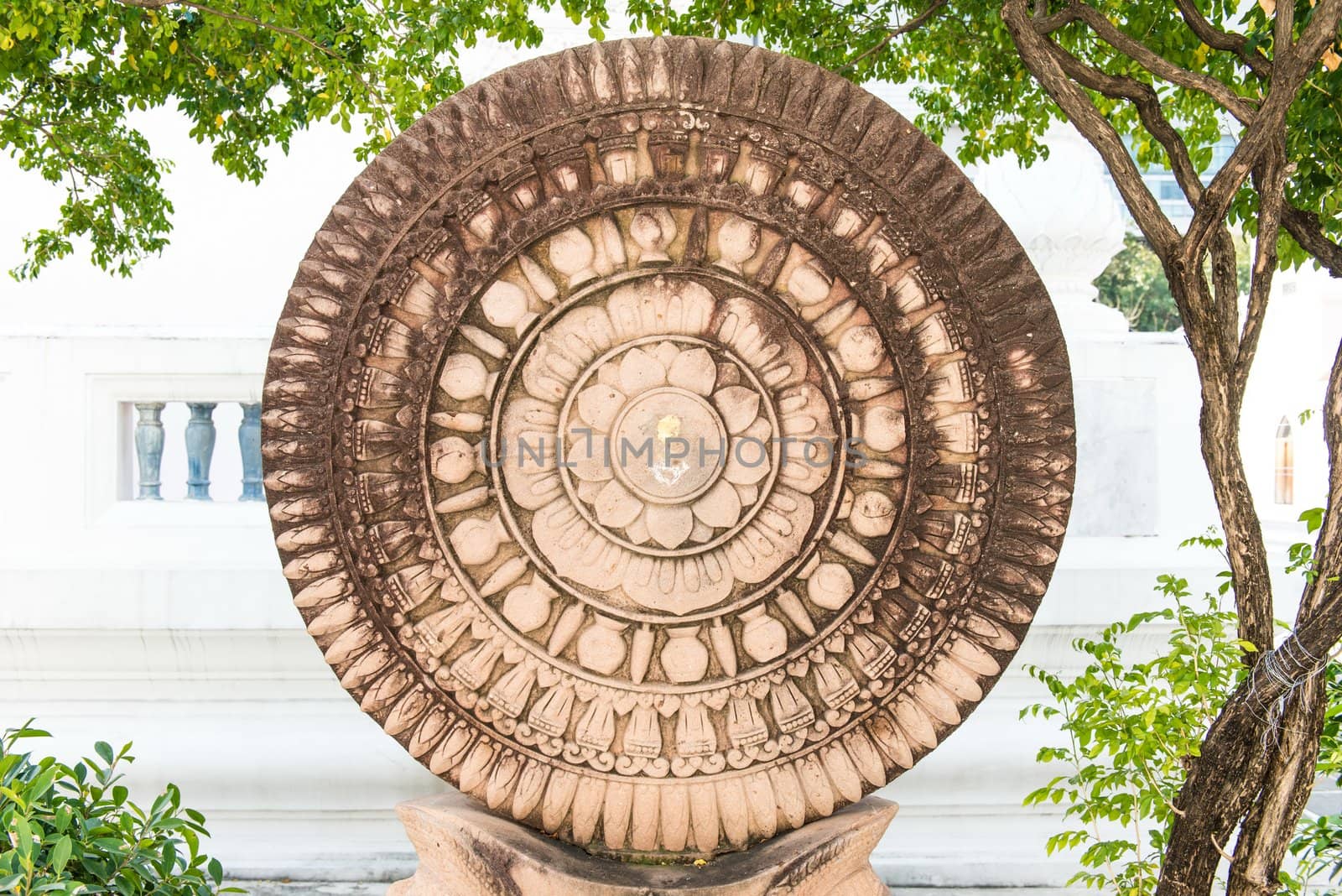 Close up of a wheel of Buddha made from lime ston by sasilsolutions
