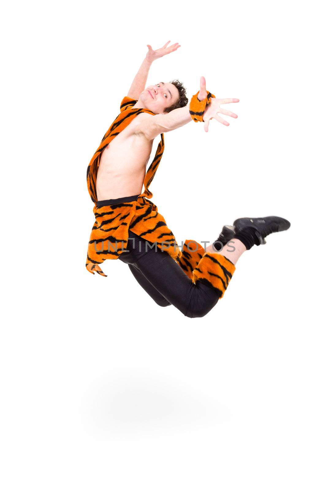 Wild man wearing a tiger fur jumping against isolated white background