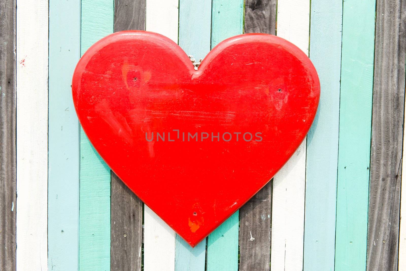 Blue, white, black contrasting old wooden texture background with heart shape, taken on a sunny day