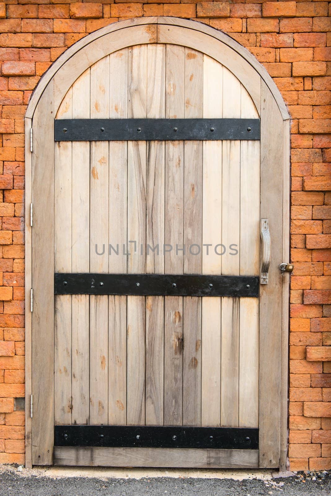 Vintage old wooden door on a red brick wall by sasilsolutions