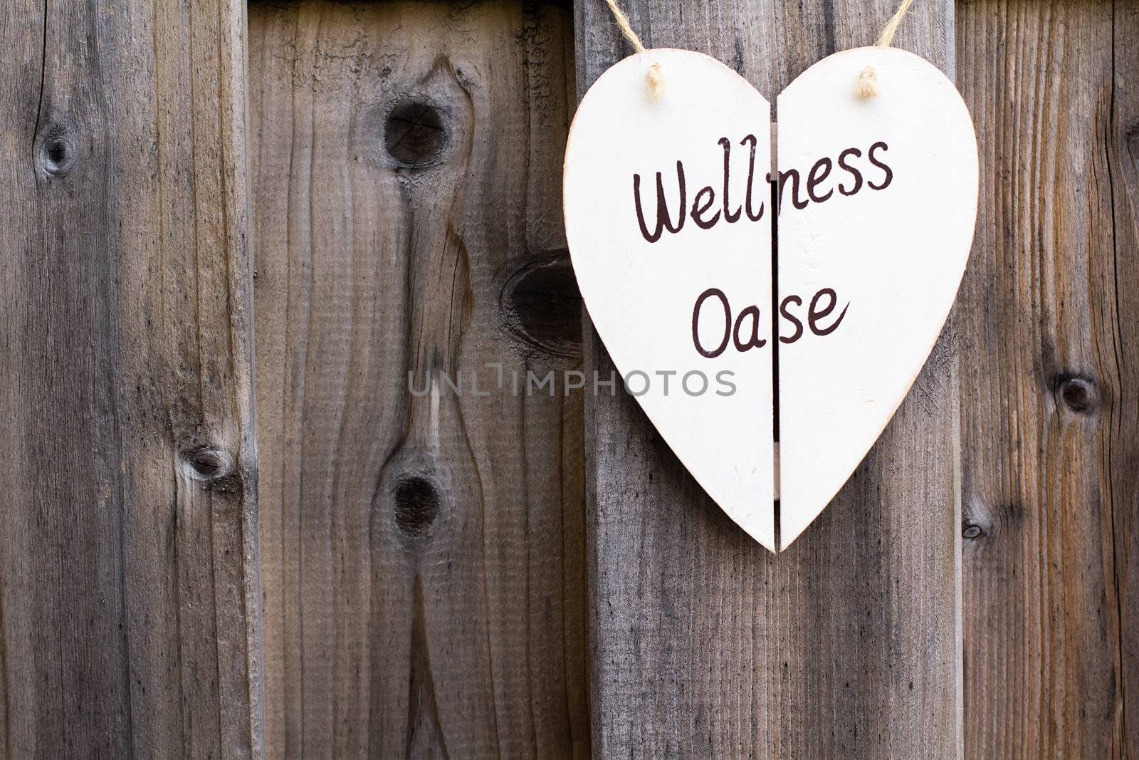 Old wooden fence with a wellness signboard background