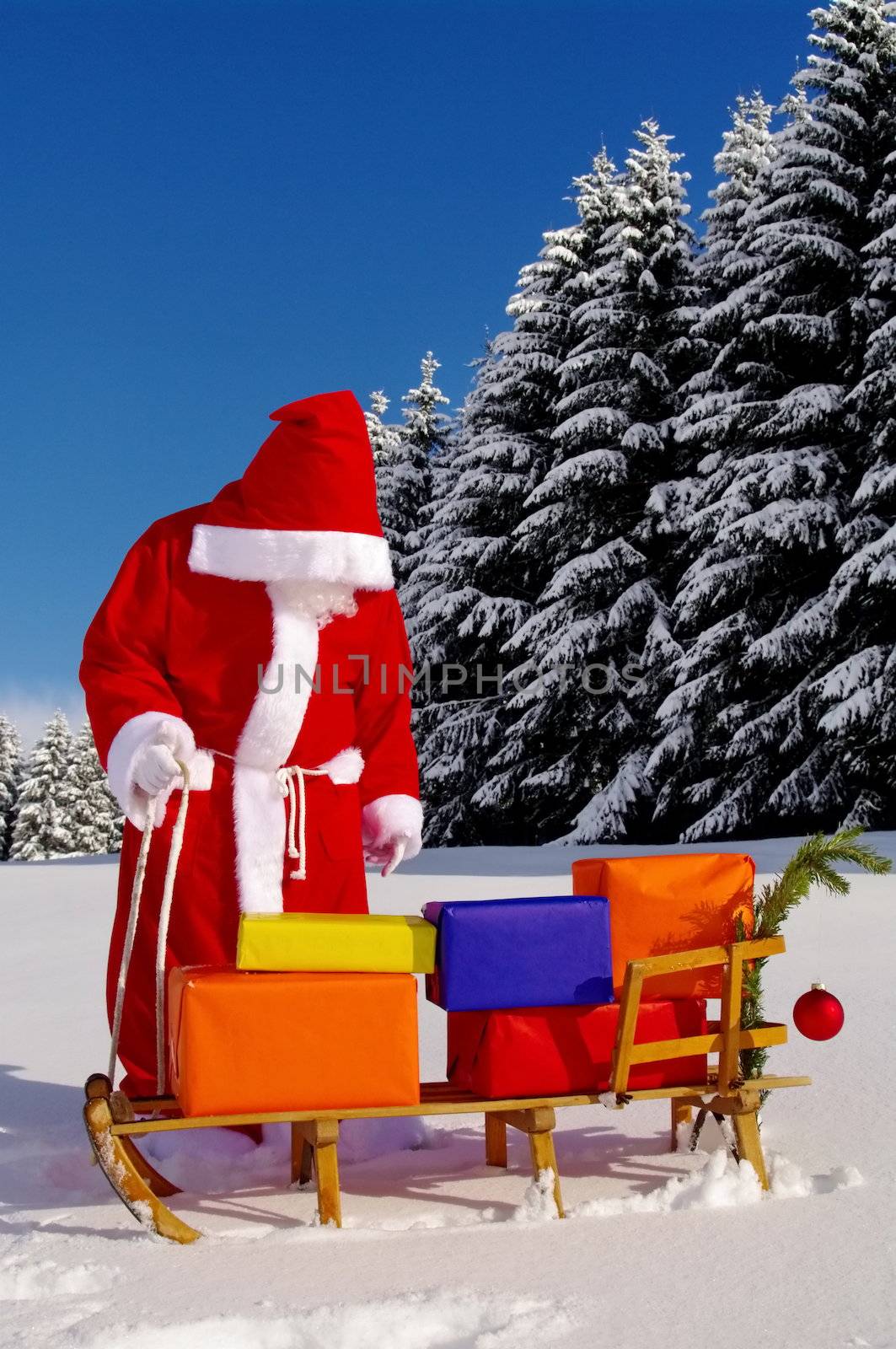 Santa Claus, Father Christmas with colorful presents on a sledge