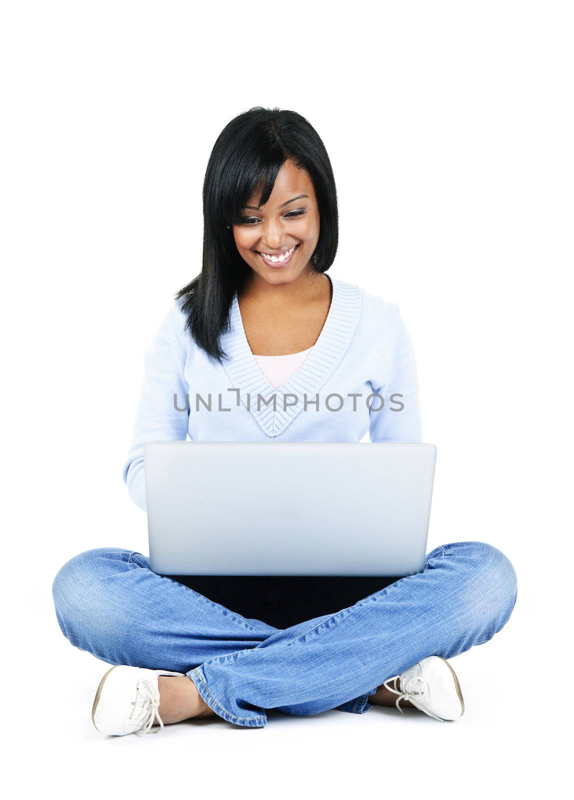 Happy black woman sitting with computer isolated on white background