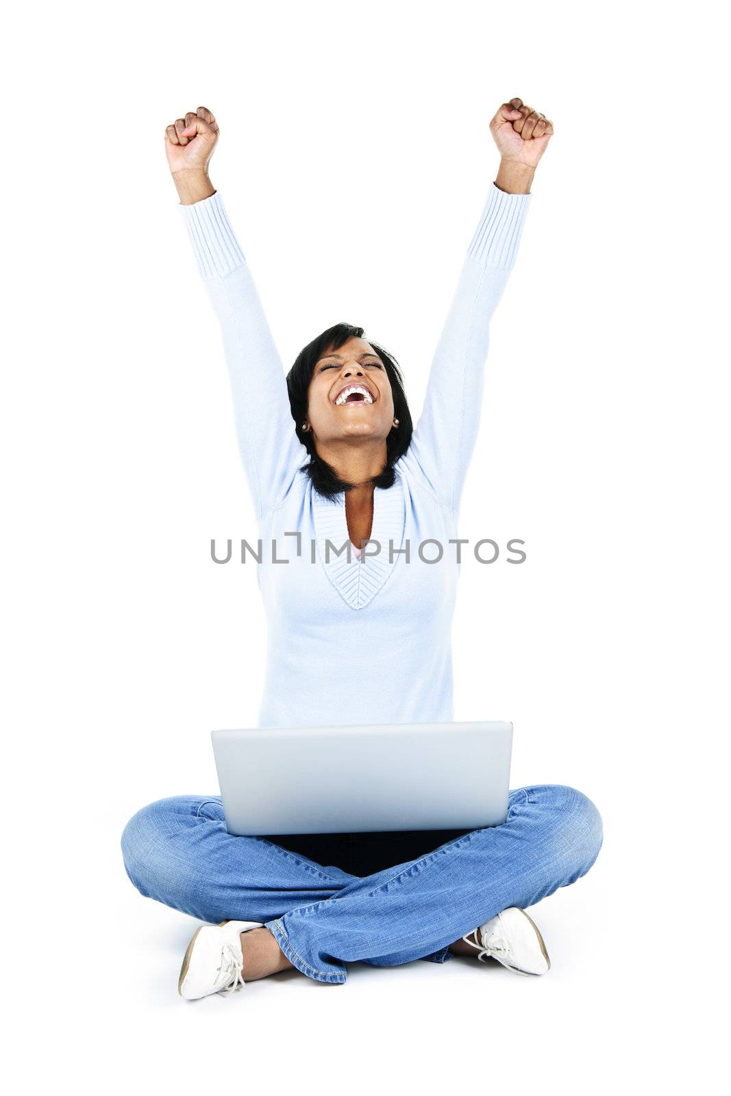 Excited black woman with arms raised and computer isolated on white background