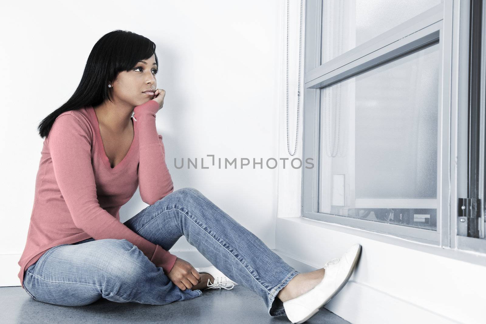 Depressed woman sitting on floor by elenathewise