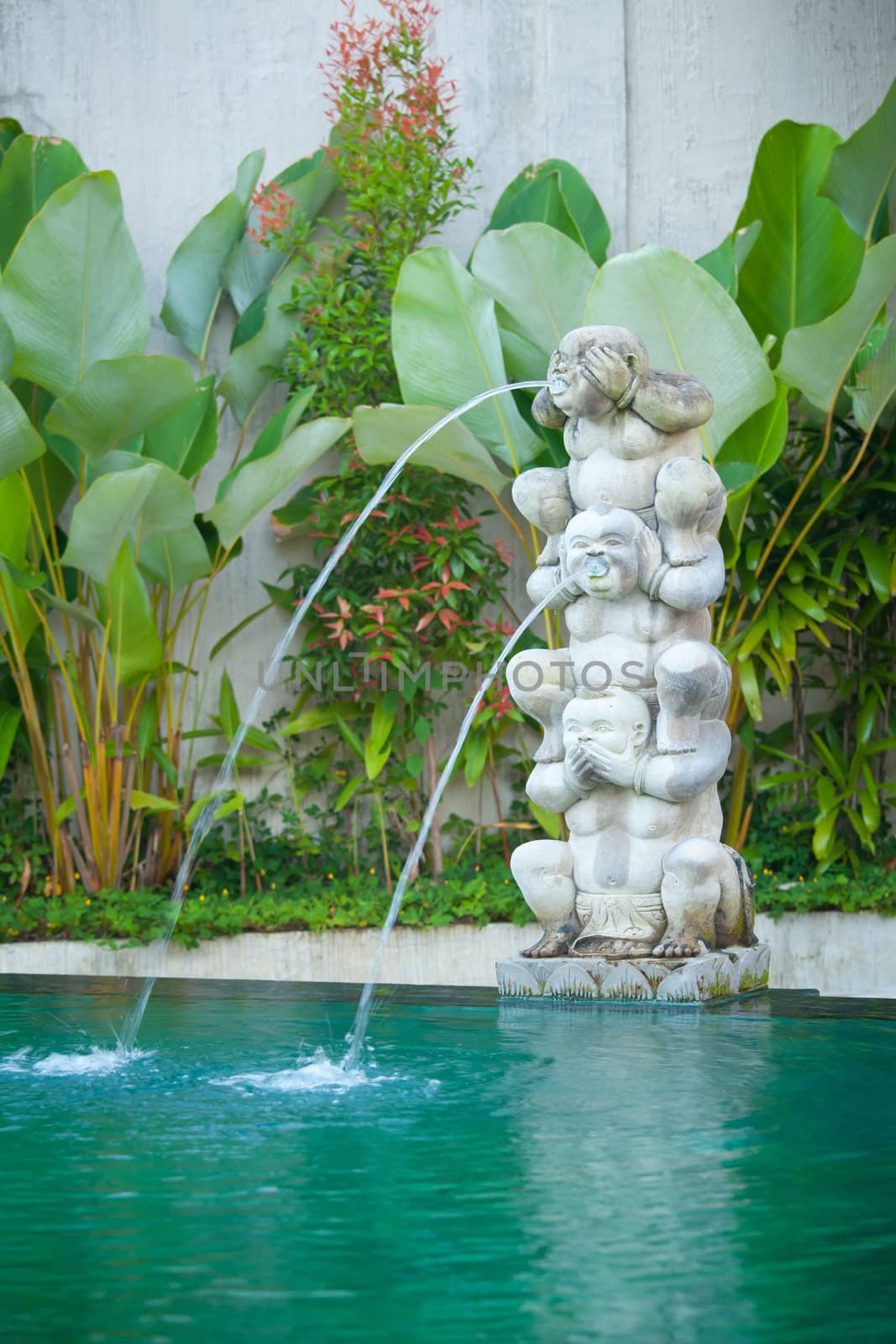 Water is released from the mouth of statues in Bali, Indonesia