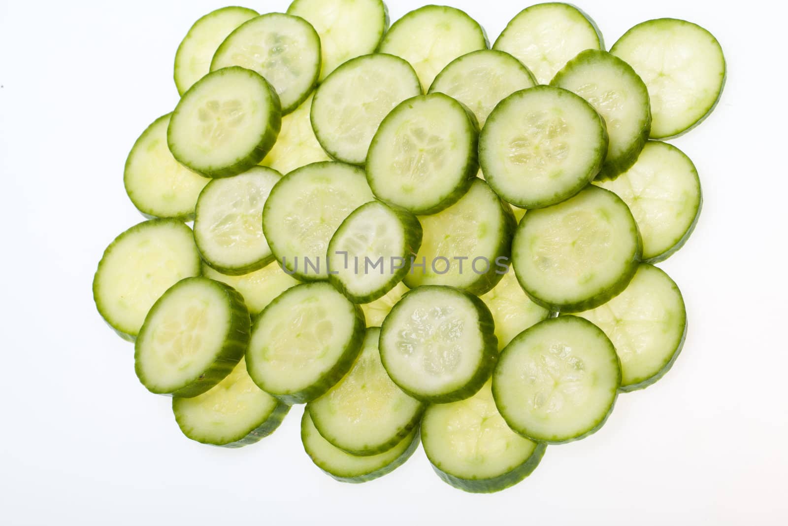 Freshly sliced cucumber  isolated on white background 
