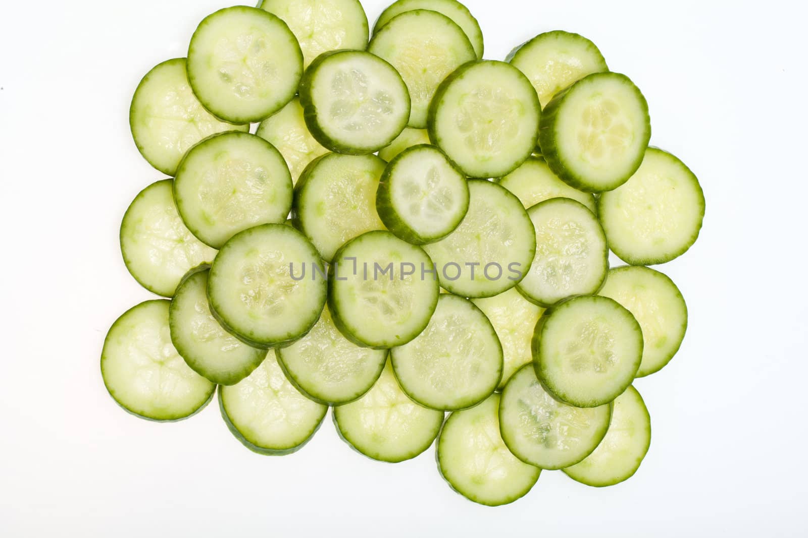Freshly sliced cucumber  isolated on white background 