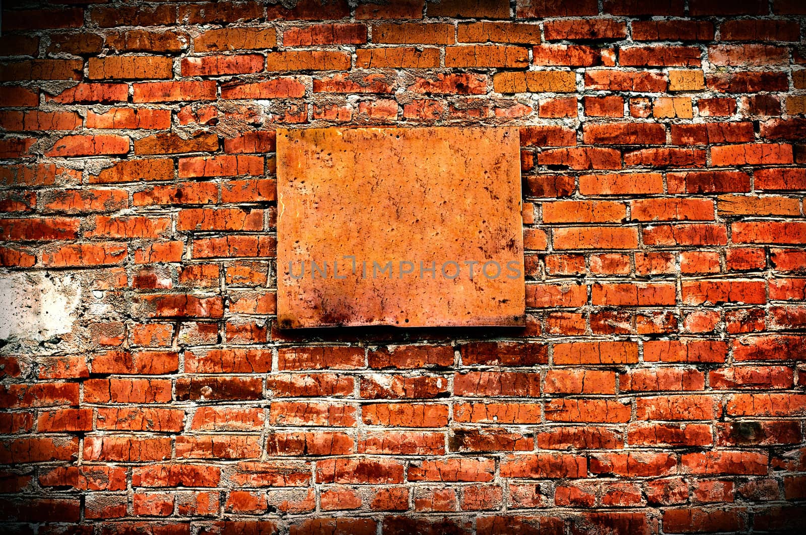 Vintage and Vignetting Photo of the Bricks Wall with Empty Board