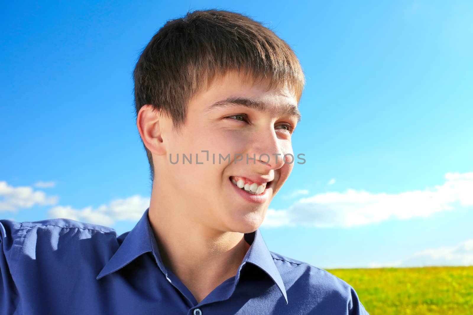 Happy Young Man Portrait in the Summer Field