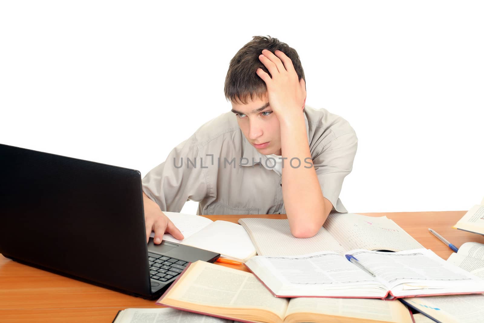 Pensive Student on the School Desk typing on laptop. Isolated on the White Background