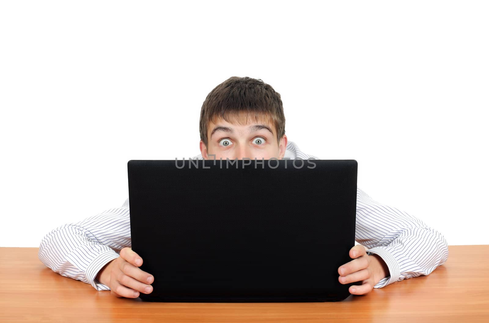 Surprised Young Man behind Laptop. Isolated on the White Background