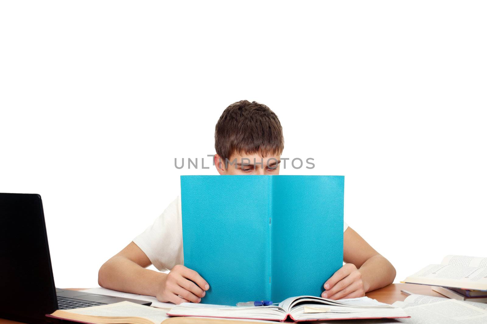Student reads workbook on the School Desk. Isolated on the White Background
